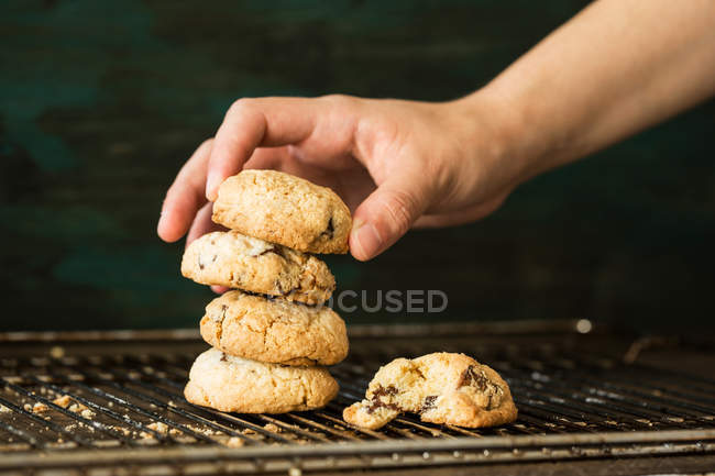 Hand putting cookies in roll — Stock Photo