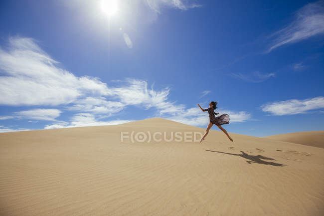 Woman in dress jumping — Stock Photo