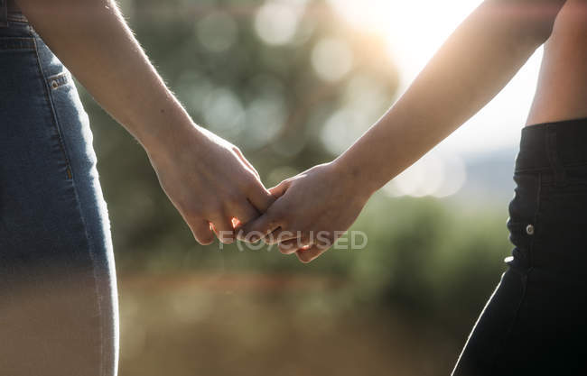 Female couple holding hands — Stock Photo