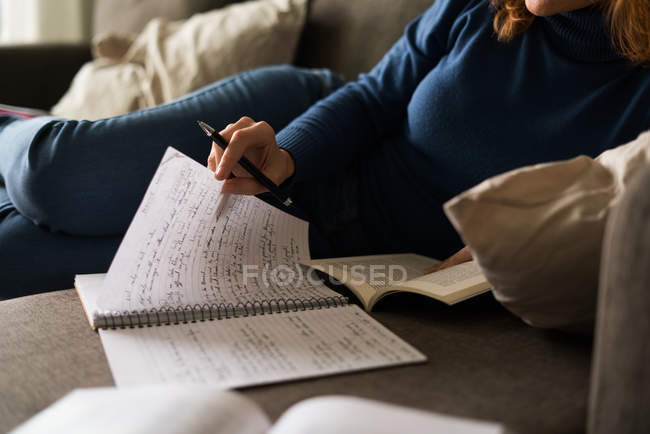 Woman lying and learning — Stock Photo