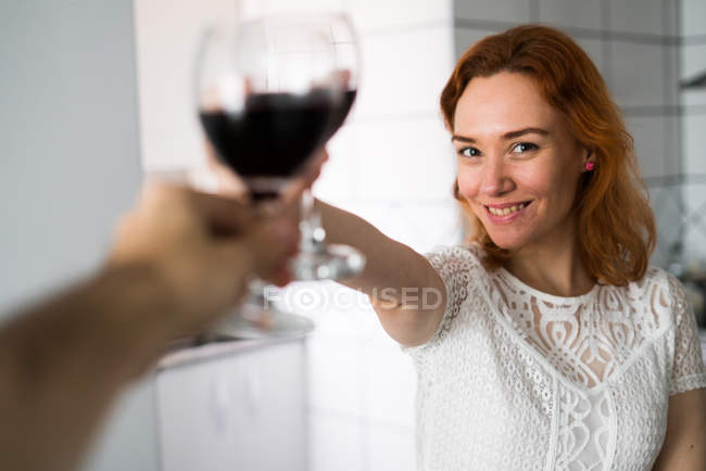 Woman clanging glasses — Stock Photo