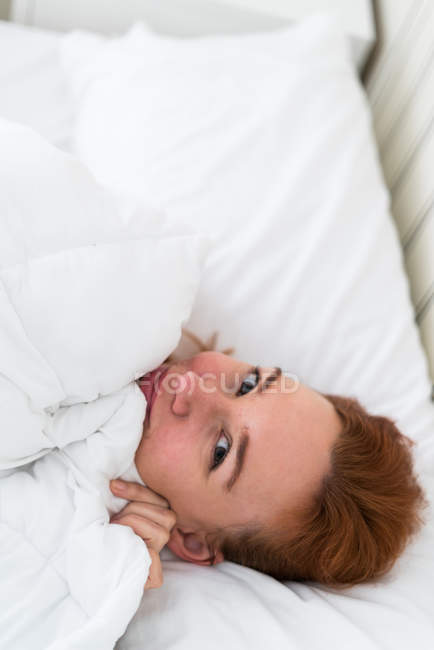 Cheerful woman in bed — Stock Photo