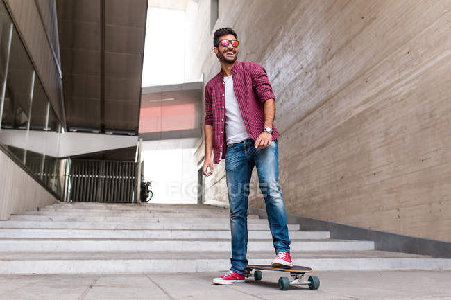 Stylish young skateboarder — Stock Photo