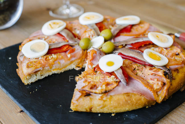 Sliced pizza with eggs — Stock Photo