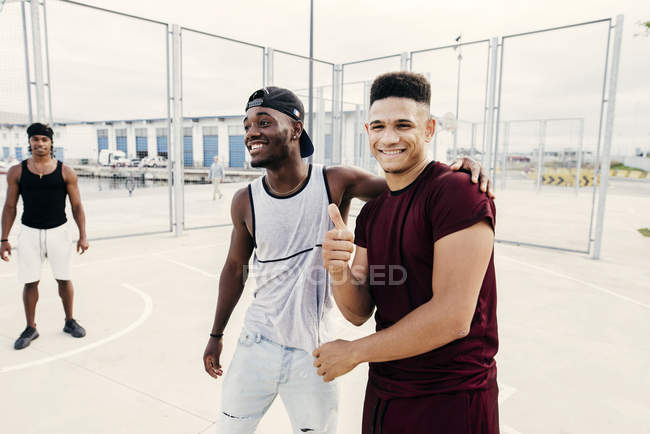 Cheerful men on sports ground — Stock Photo