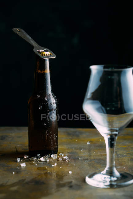 Bottle of cold beer on dark — Stock Photo