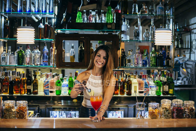 Female bartender serving cocktail — Stock Photo