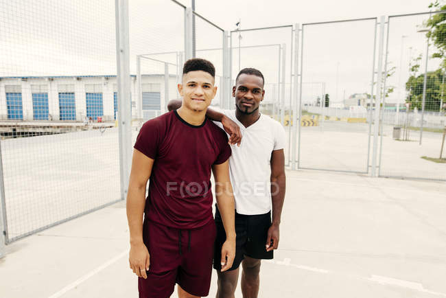 Young sportive men posing in squat — Stock Photo