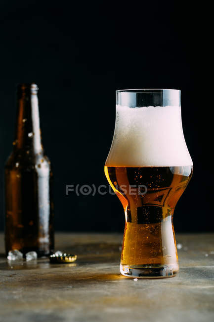 Glass of cold beer on dark — Stock Photo
