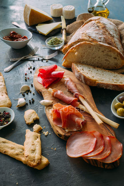 Board with snacks and appetizers — Stock Photo