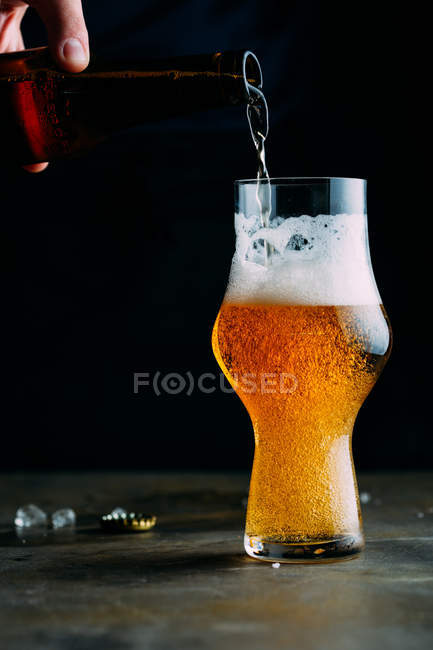 Чоловік подає стакан холодного пива — стокове фото