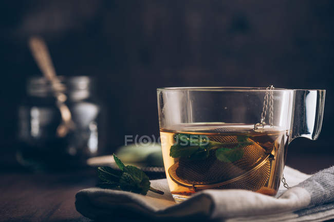Steaming cup of tea on dark — Stock Photo