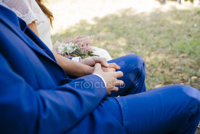 Wedding couple holding hands — Stock Photo