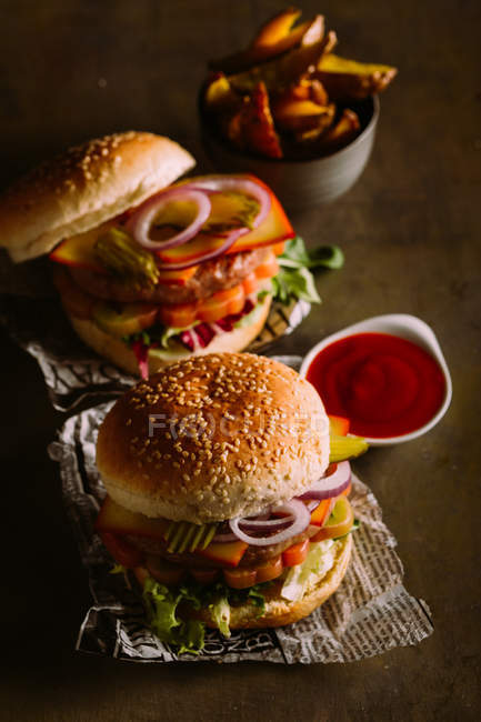 Gourmet burger on dark — Stock Photo