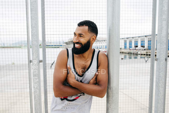 Sportive man posing in squat — Stock Photo