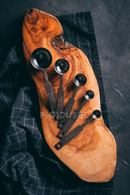 Measuring spoons on wooden board — Stock Photo