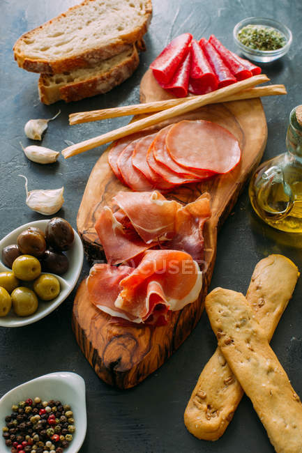 Board with snacks and appetizers — Stock Photo