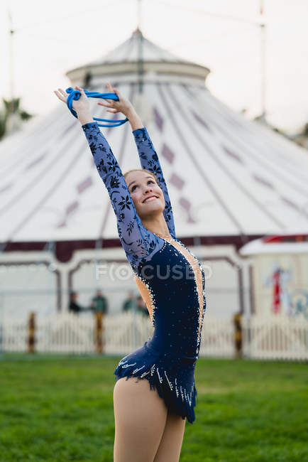 Cheerful gymnast stretching with string — Stock Photo