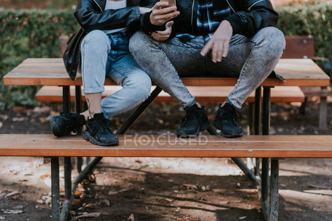Low section of coupe sitting on park table — Stock Photo