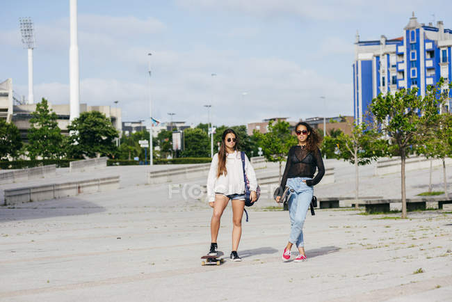 Trendy girls on skateboards — Stock Photo