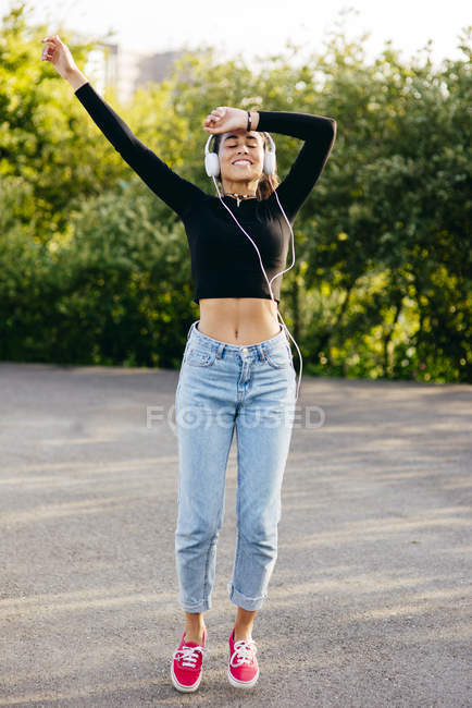 Cheerful happy teen in headphones — Stock Photo