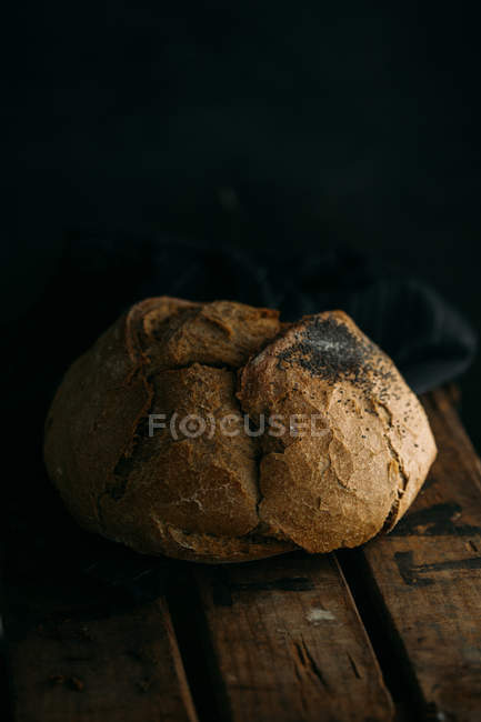 Rustic bread on dark — Stock Photo