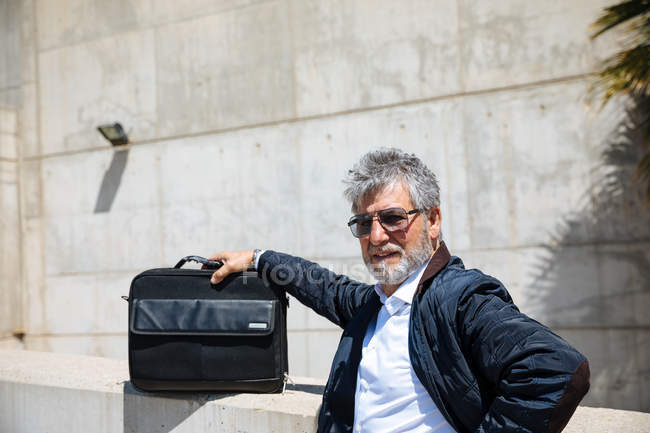 Successful man with suitcase — Stock Photo