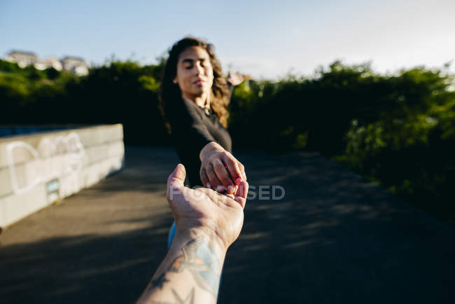 Girl holding male hand — Stock Photo
