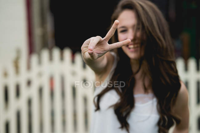 Young female showing two fingers — Stock Photo