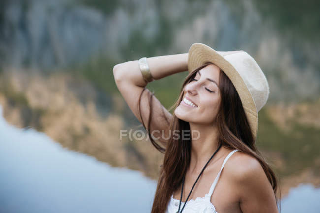beautiful smiling girl in cap posing at tropical beach Stock Photo by  LightFieldStudios