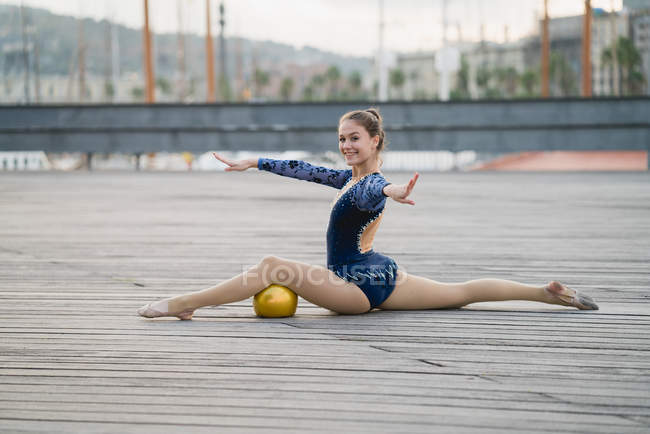 Female gymnast posing at pier — Stock Photo