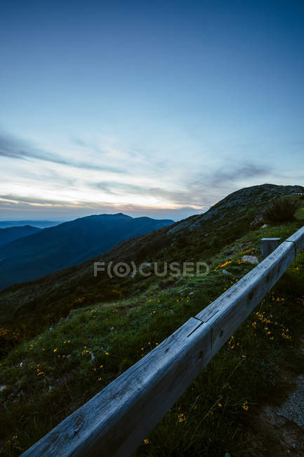 Lawn fading into mountains landscape — Stock Photo