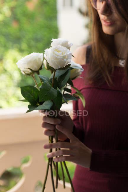 Beautiful female holding roses — Stock Photo