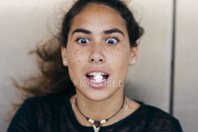 Girl with popcorn in mouth — Stock Photo