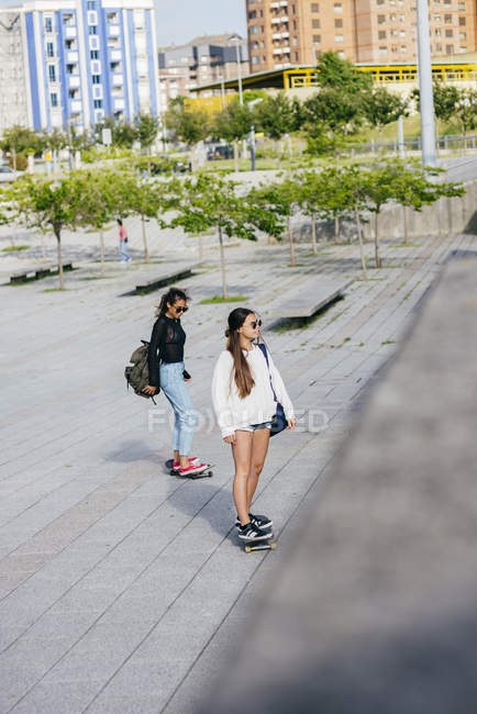 Trendy girls on skateboards — Stock Photo
