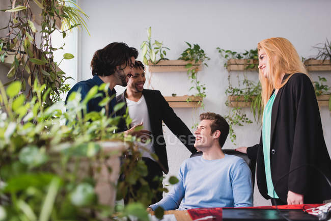 Office scene of workers laughing at workplace — Stock Photo