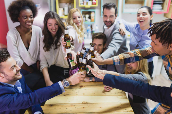 High angle view of people clanging bottles in  office while teambuilding — Stock Photo