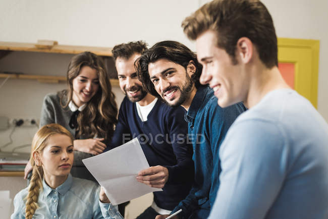 Group of cheerful business people in trendy office — Stock Photo