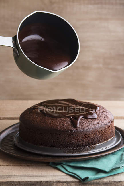 Chef pouring melted dark chocolate — Stock Photo