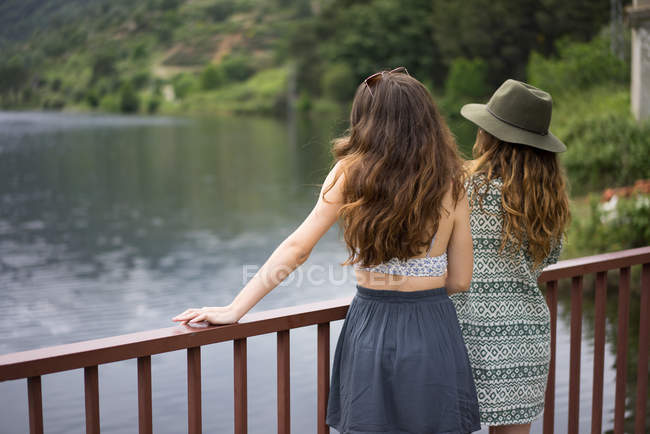 Two girls posing on bridge — Stock Photo
