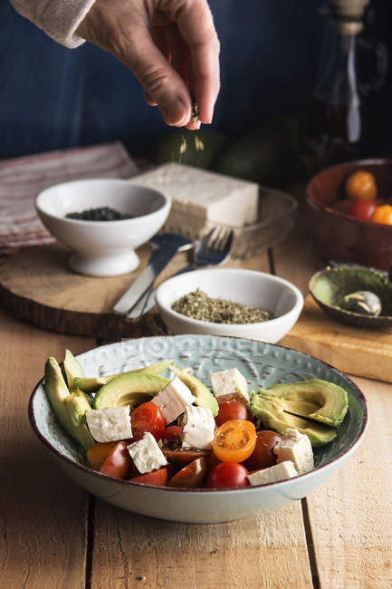Tomato salad with feta cheese, avocados — Stock Photo