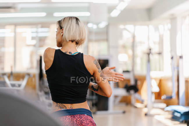Athletic woman stretching in Gym — Stock Photo