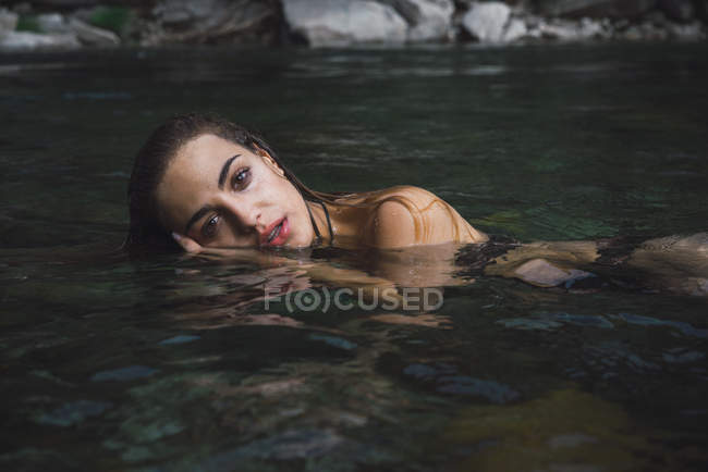 Beautiful girl posing in water — Stock Photo
