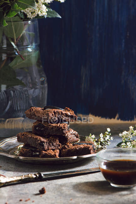 Metal plate with pile of brownies — Stock Photo