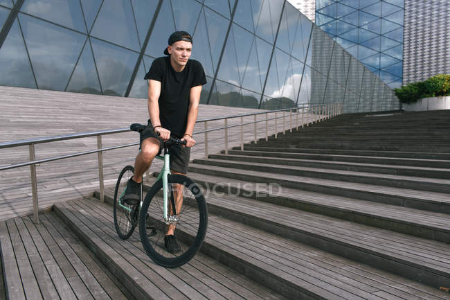 Man sitting on bike — Stock Photo