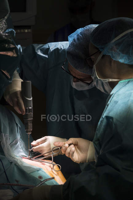 Medics using drill while operation — Stock Photo