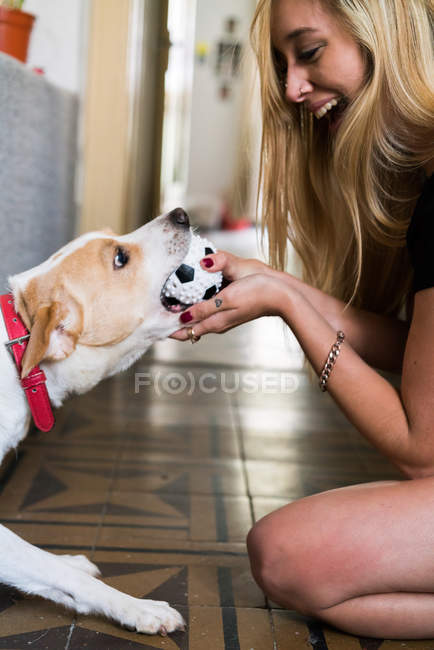 Donna che gioca con il cane — Foto stock