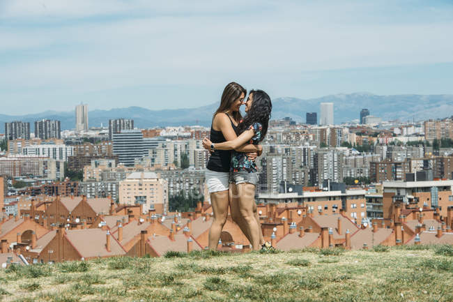 Lovely young girlfriends embracing — Stock Photo