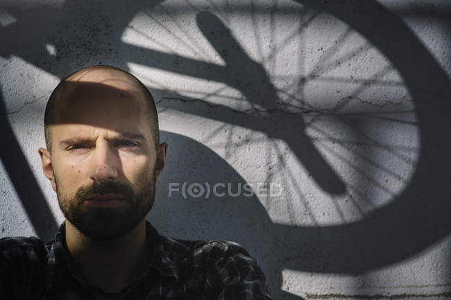 A bicycler with wheel shadow — Stock Photo