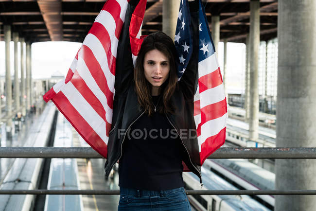 A woman with flag on a station — Stock Photo